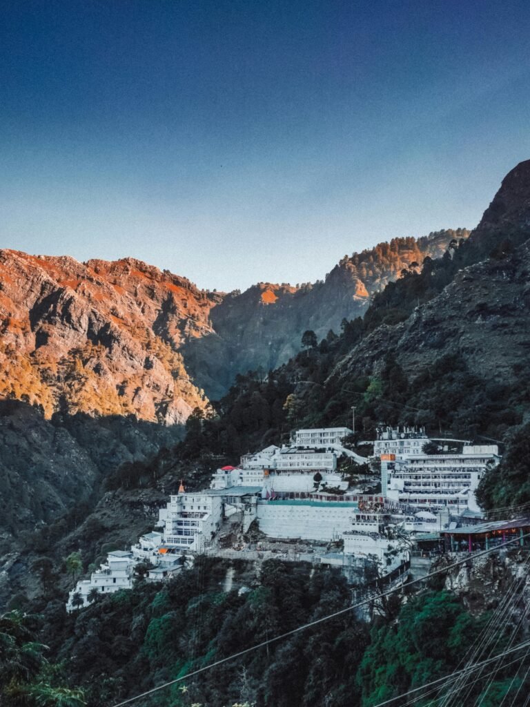 Stunning view of a mountain resort nestled within rugged peaks under a blue sky.