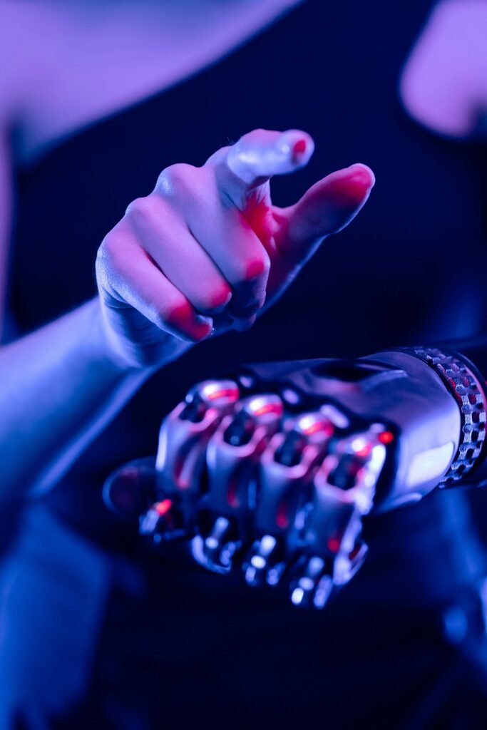 Close-up of a prosthetic arm in blue and pink neon light, showcasing advanced tech.